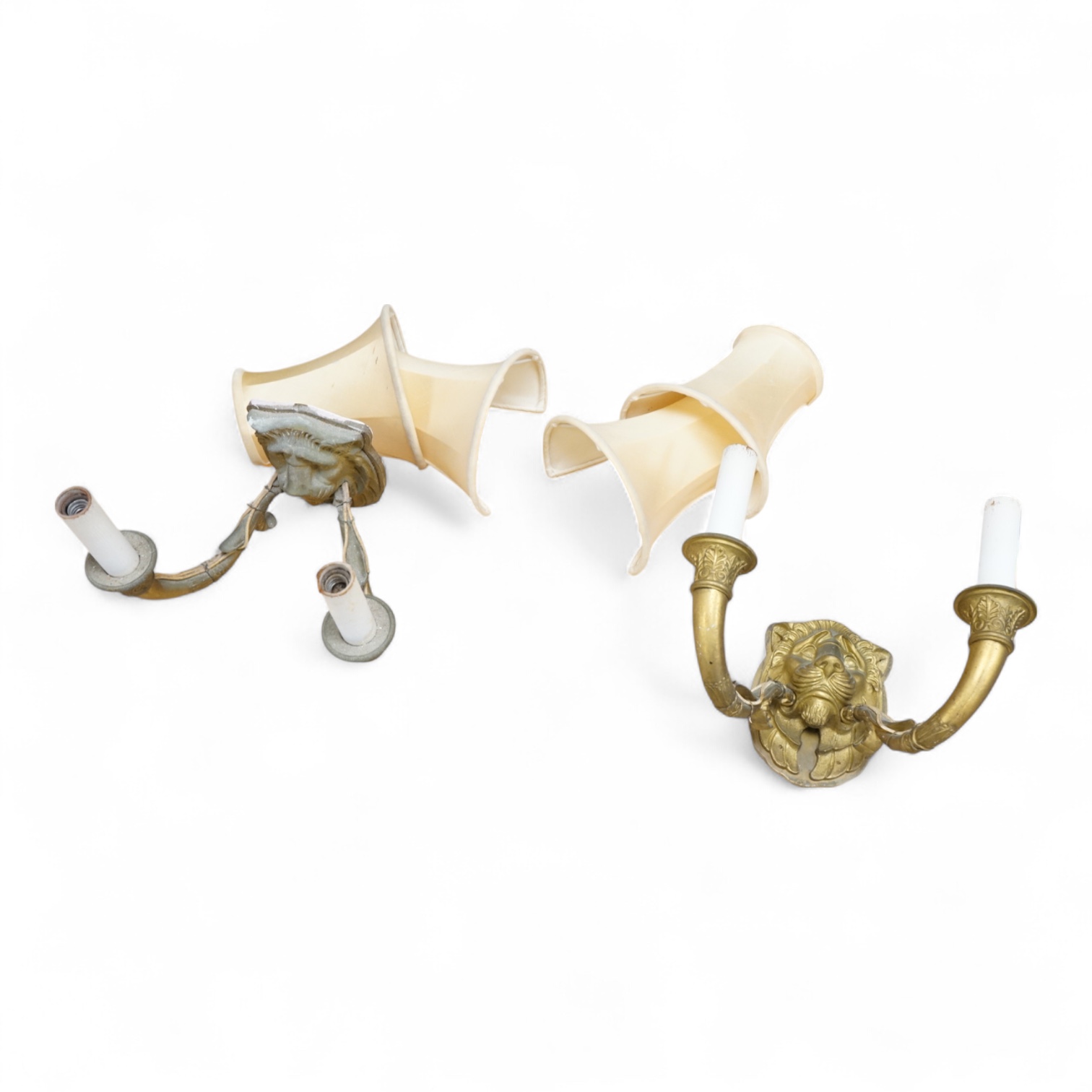 A pair of ‘lion mask’ gilt metal two branch wall sconces and four silk shades, 22cm wide